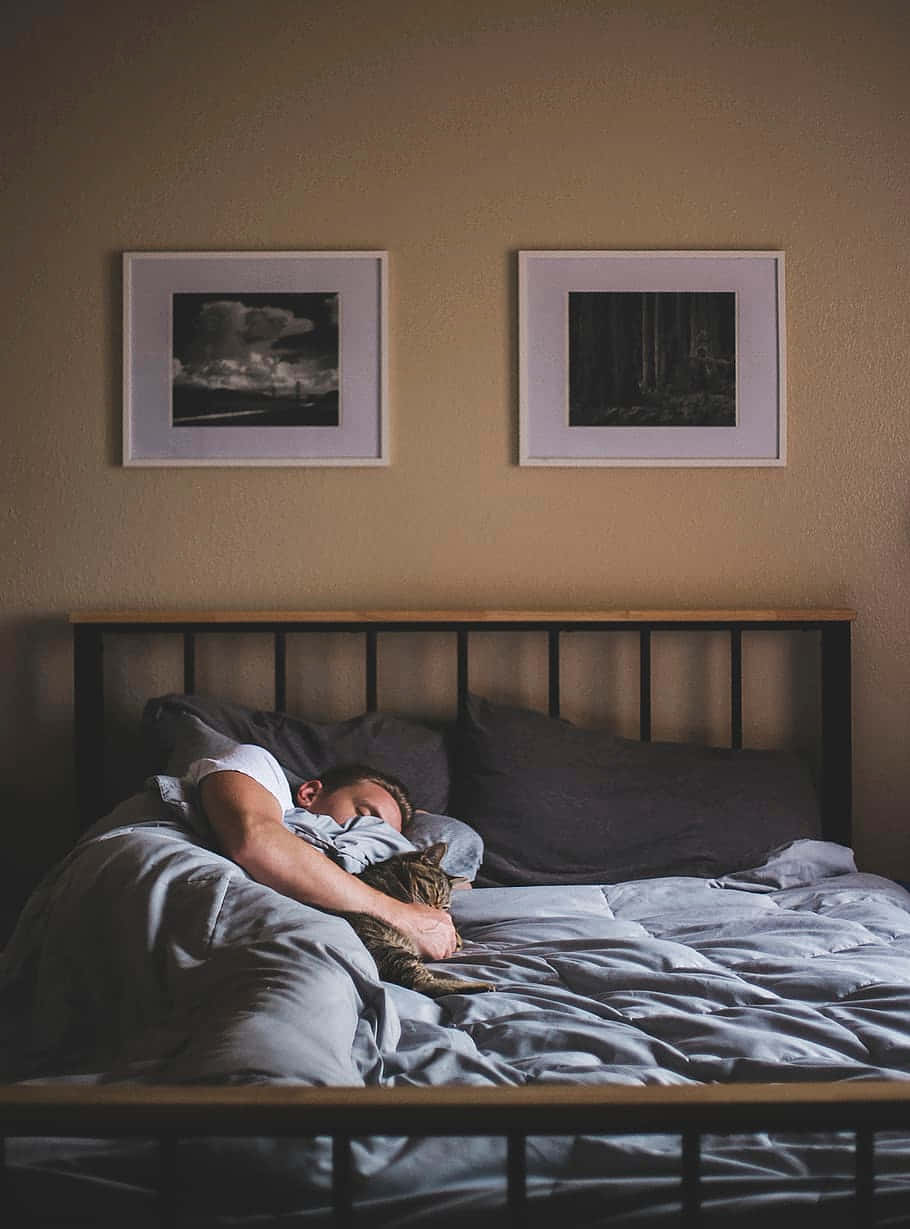 Sleeping Man In A Wide Bed Wallpaper