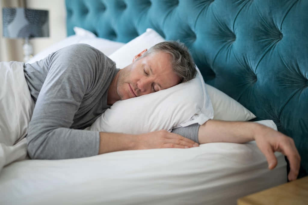Sleeping Man In White Bed Wallpaper