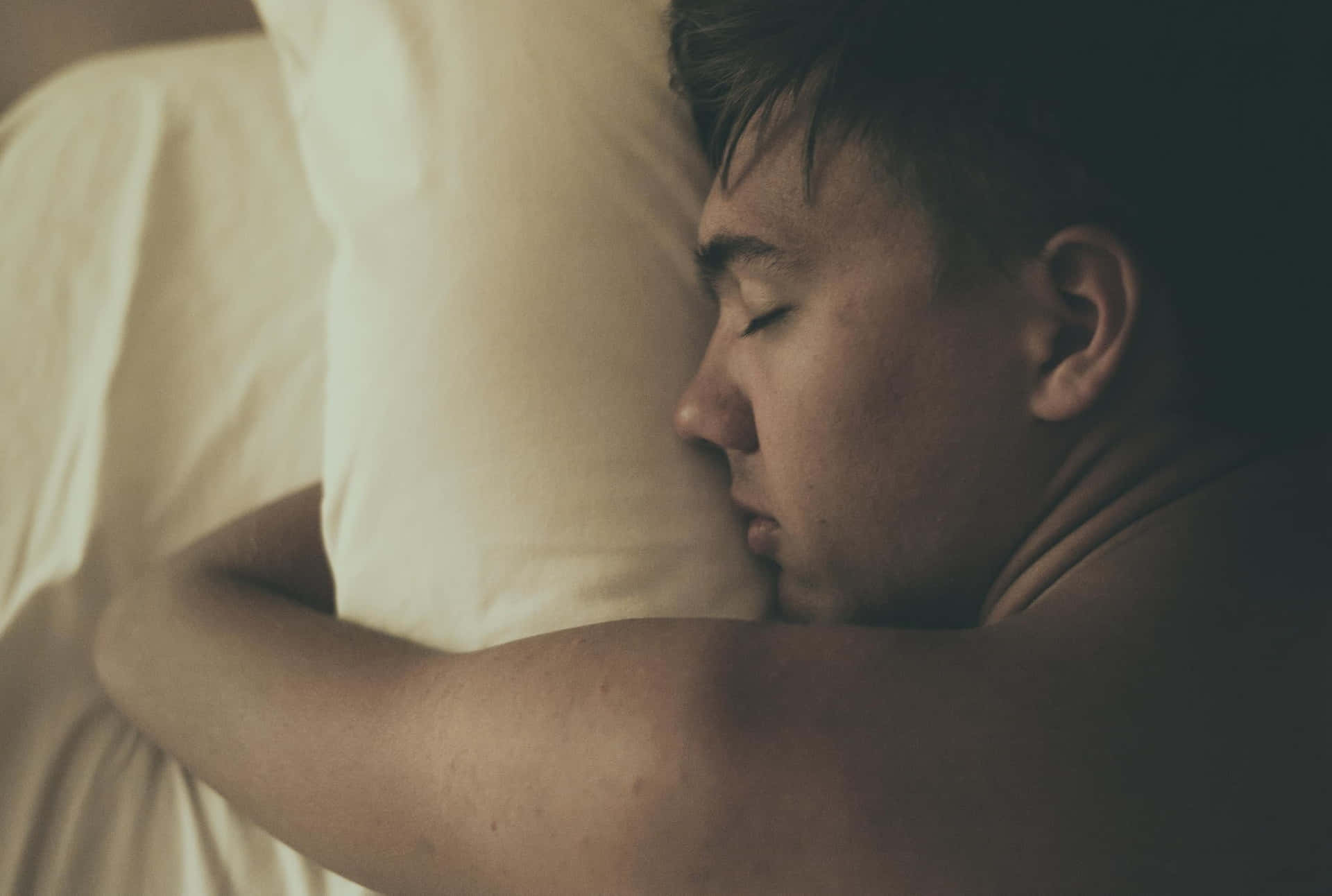 Sleeping Person Hugging A Pillow Wallpaper