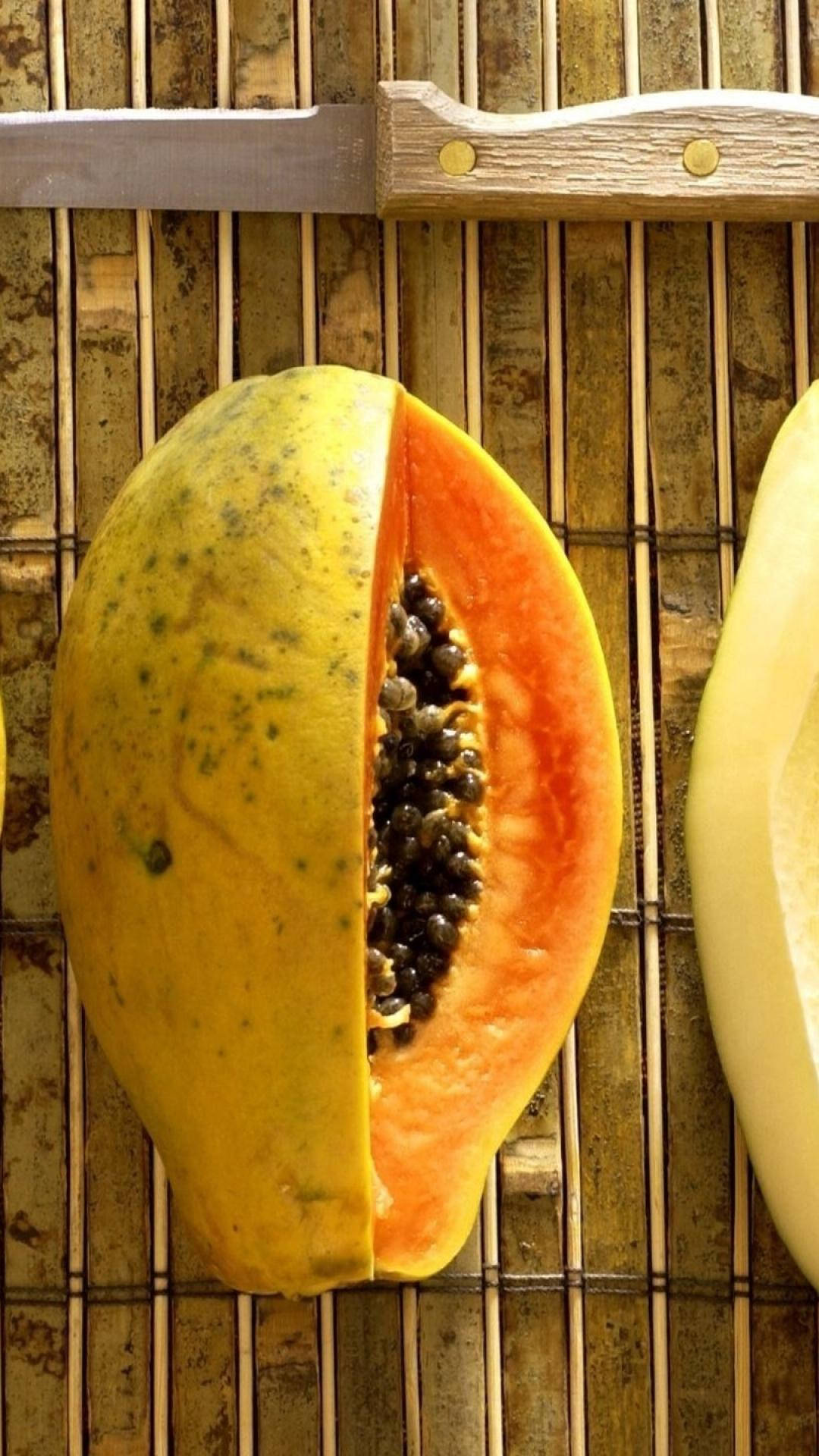 Download Sliced Fresh Papaya Fruit On Bamboo Mat Wallpaper 