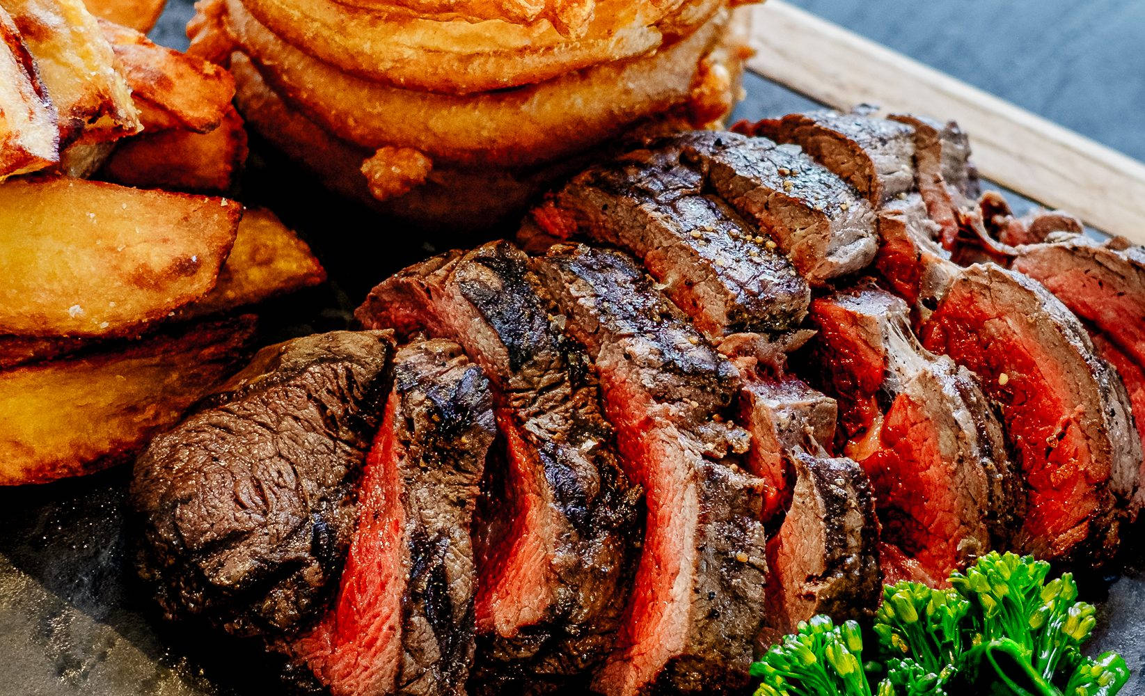Succulent Medium-Rare Steak Sizzled on a Parrilla Wallpaper