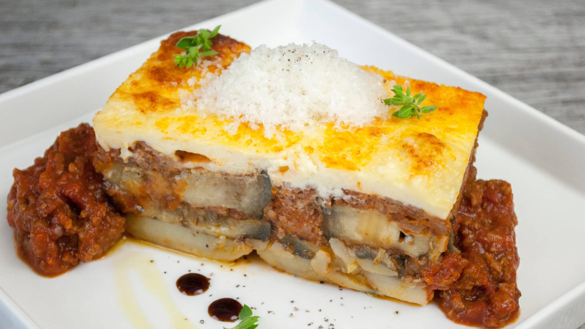 Deliciously Served Sliced Moussaka on a Square Plate Wallpaper