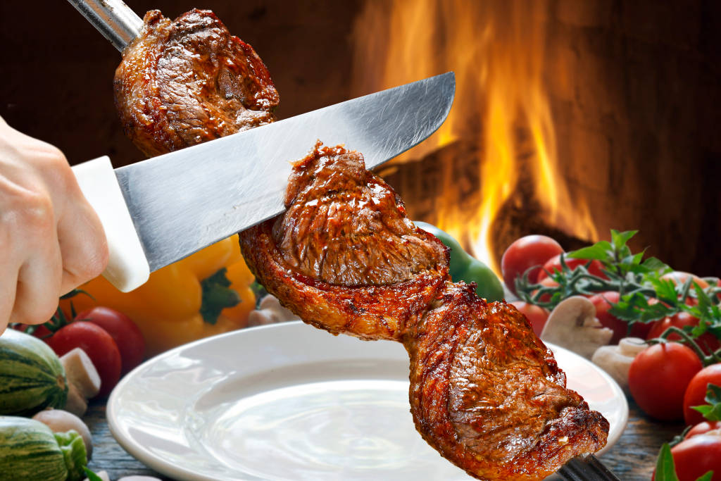 Slicing Churrasco With Knife Wallpaper