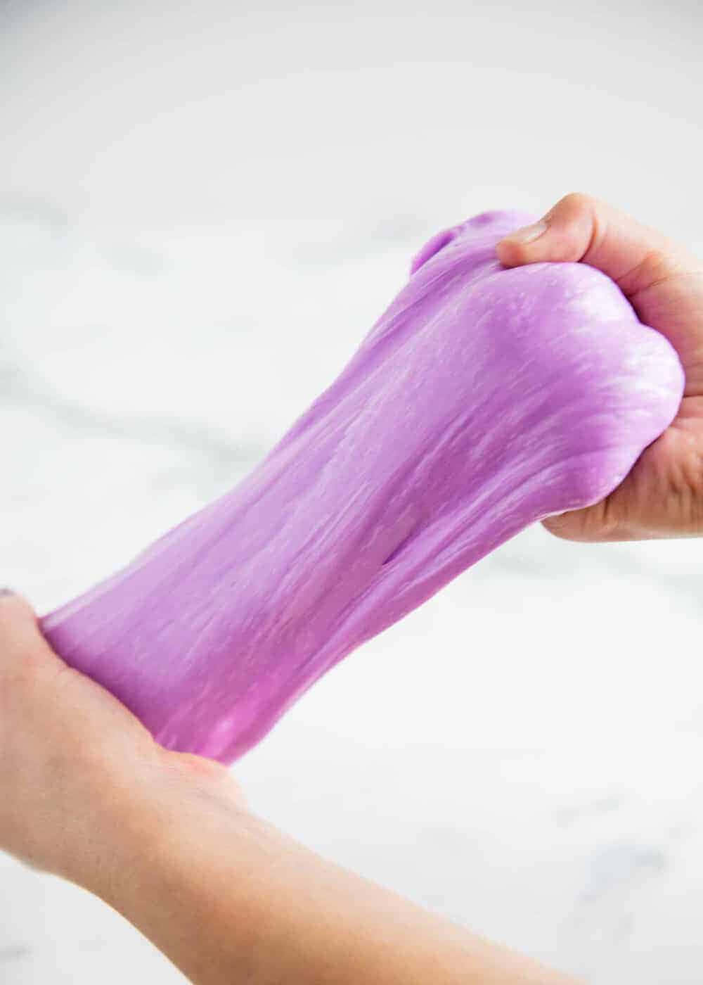 A Person Is Holding A Purple Slime Ball
