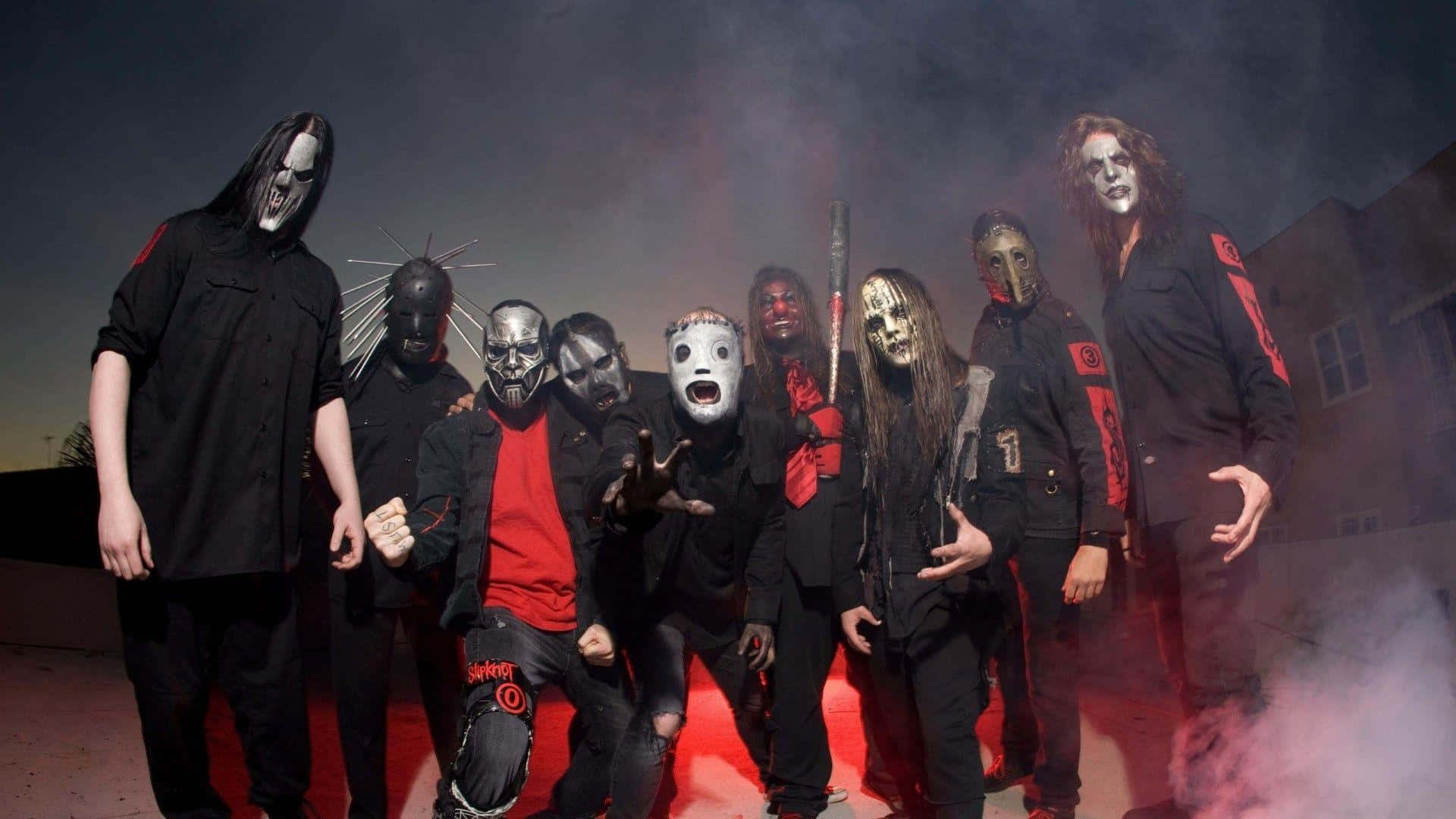 Heavy metal band Slipknot in dark attire performing on stage Wallpaper