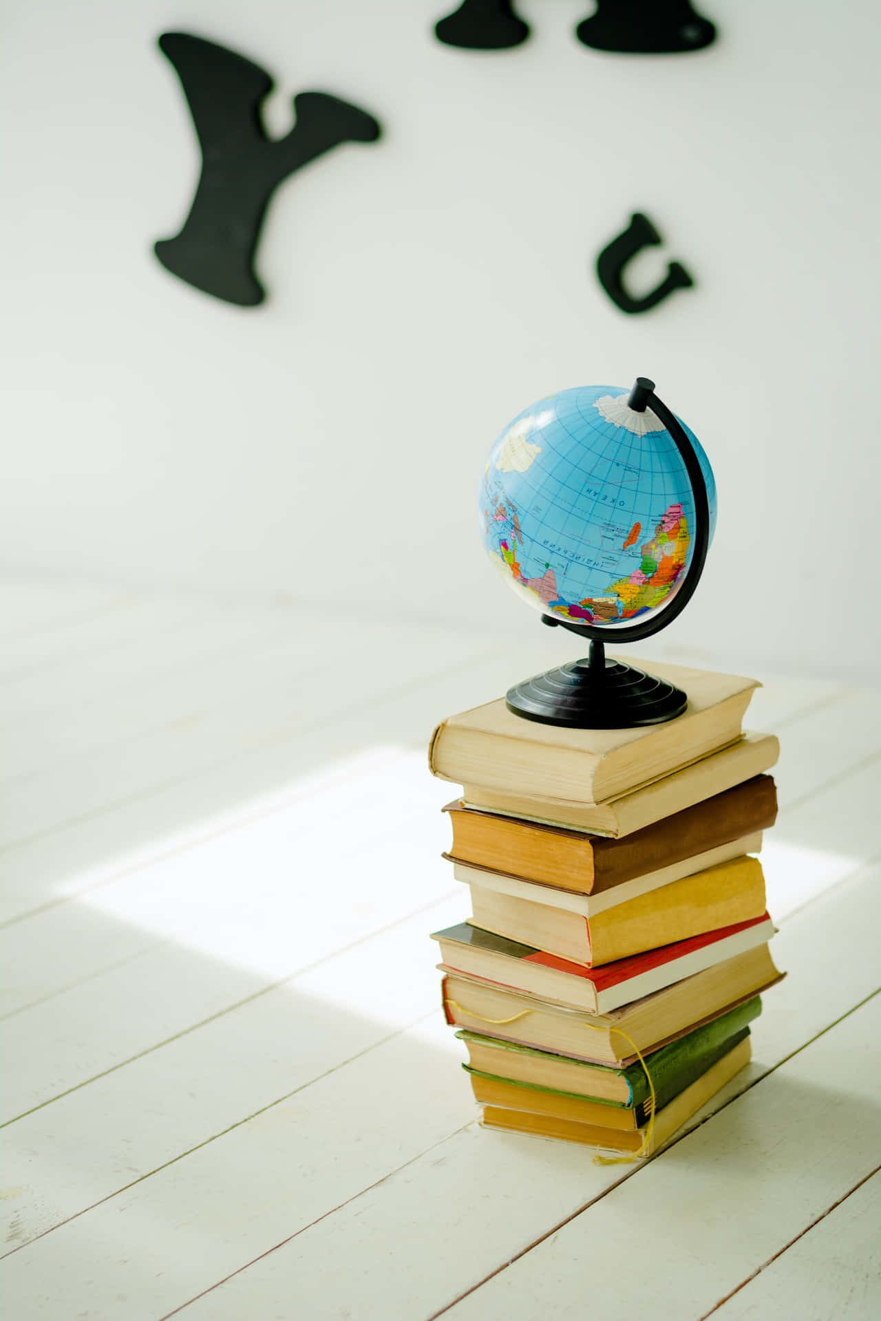 Small Globe Map On Stacked Books Wallpaper