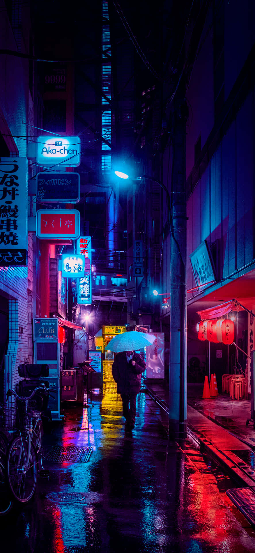 A Wet Street With A Lot Of Neon Lights Wallpaper