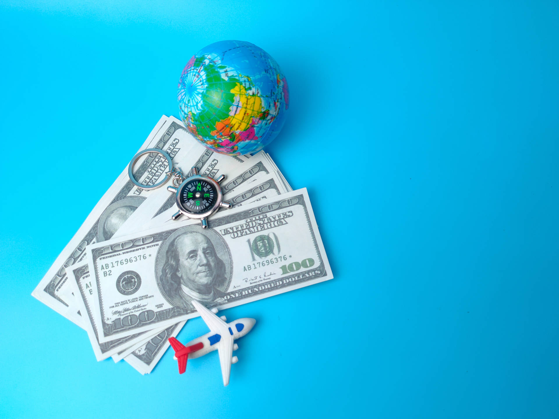 Small Plane Beside Dollar Bills&Globe Wallpaper