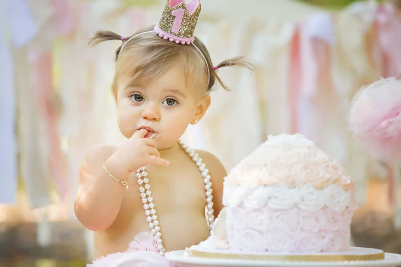 A Baby Girl In A Pink Tutu And A Pink Cake