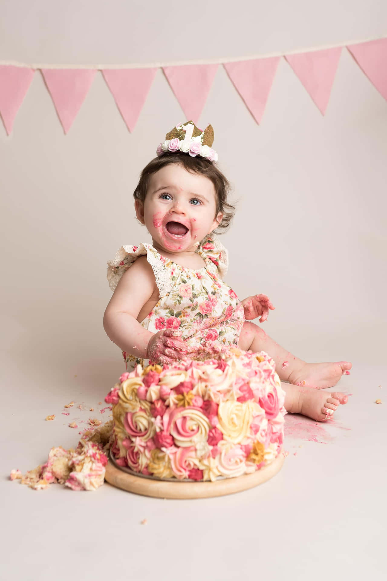 A Baby Girl Is Sitting In Front Of A Cake