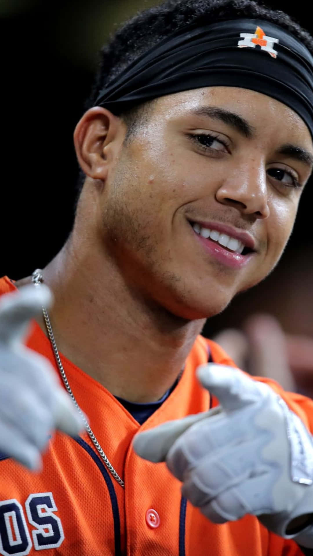 Smiling Baseball Playerin Orange Jersey Wallpaper