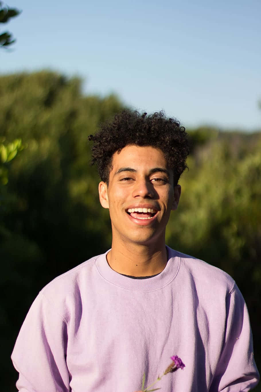 Smiling Boyin Purple Sweatshirt Outdoors Wallpaper