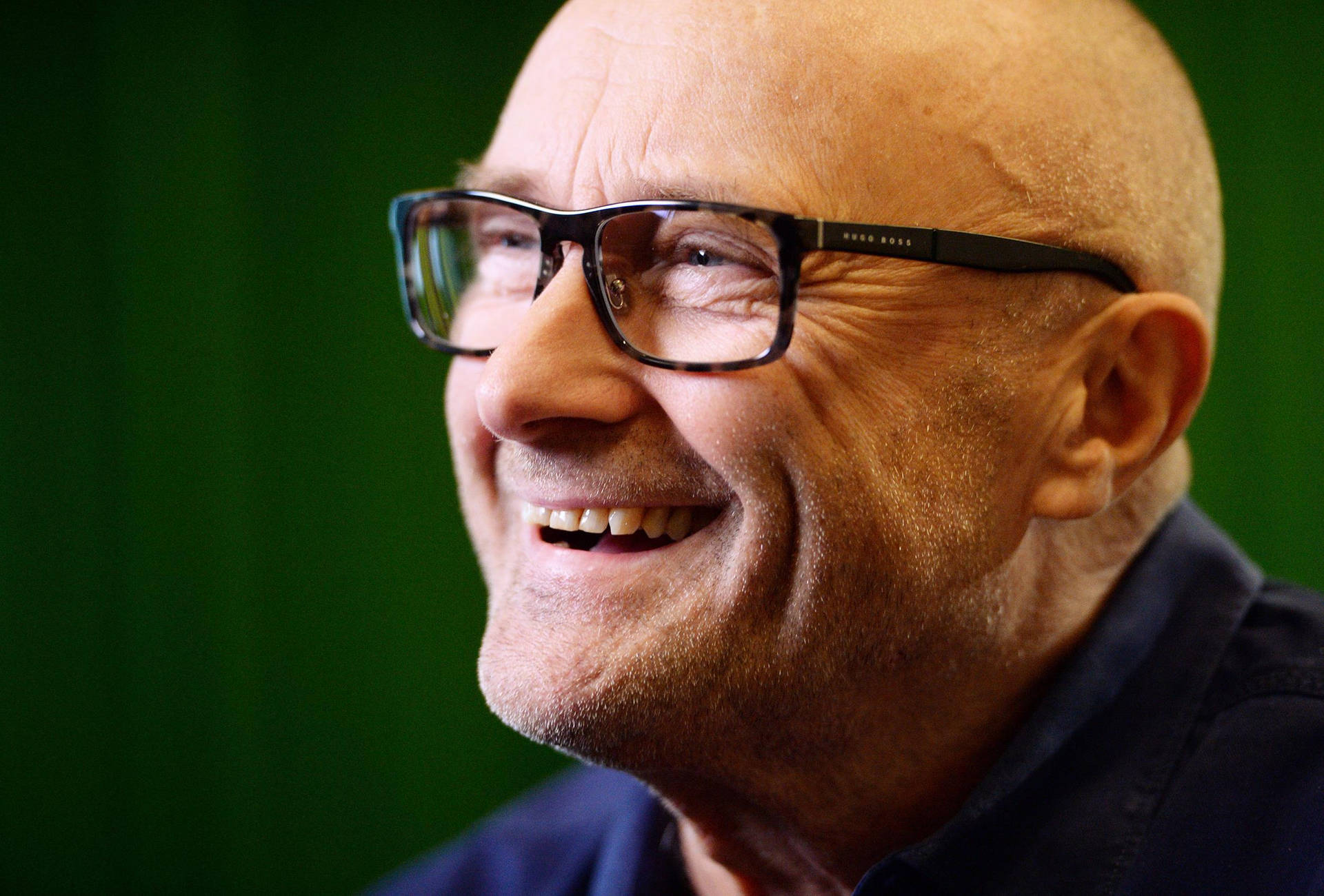Acclaimed British Songwriter Phil Collins smiling for a portrait. Wallpaper