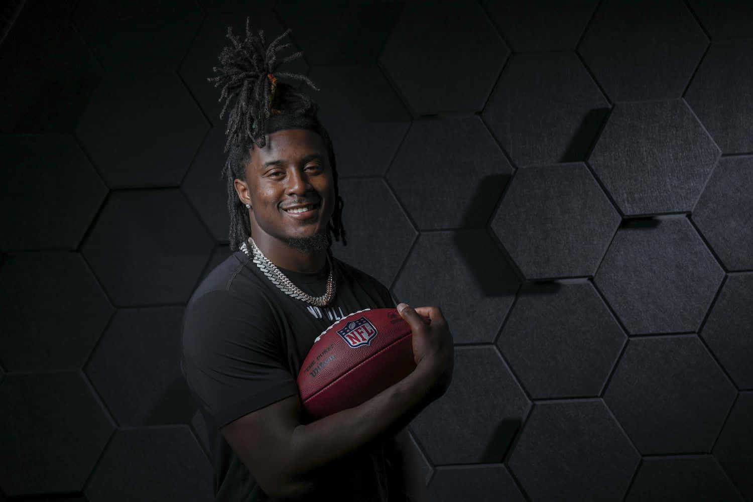 Smiling Football Player Holding N F L Ball Wallpaper