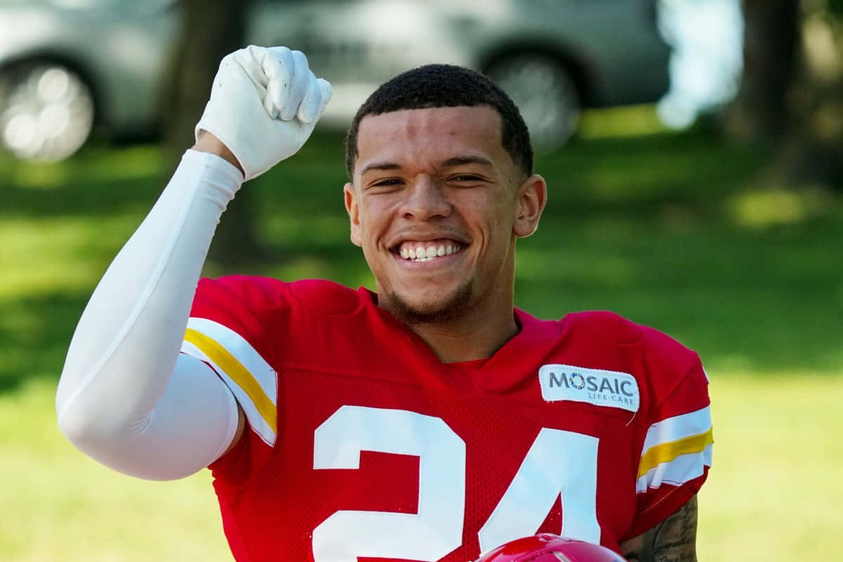 Smiling Football Player Outdoors Wallpaper