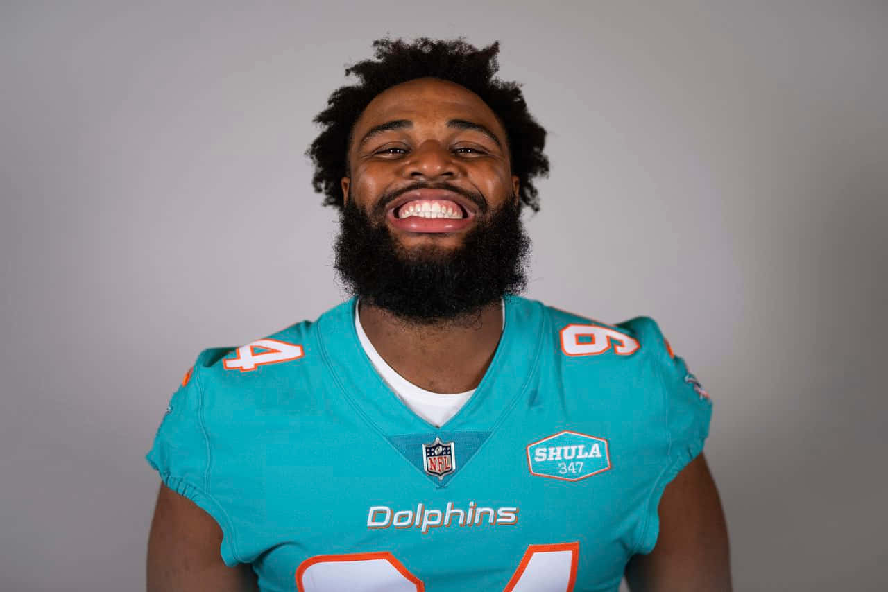 Smiling Football Playerin Dolphins Jersey Wallpaper
