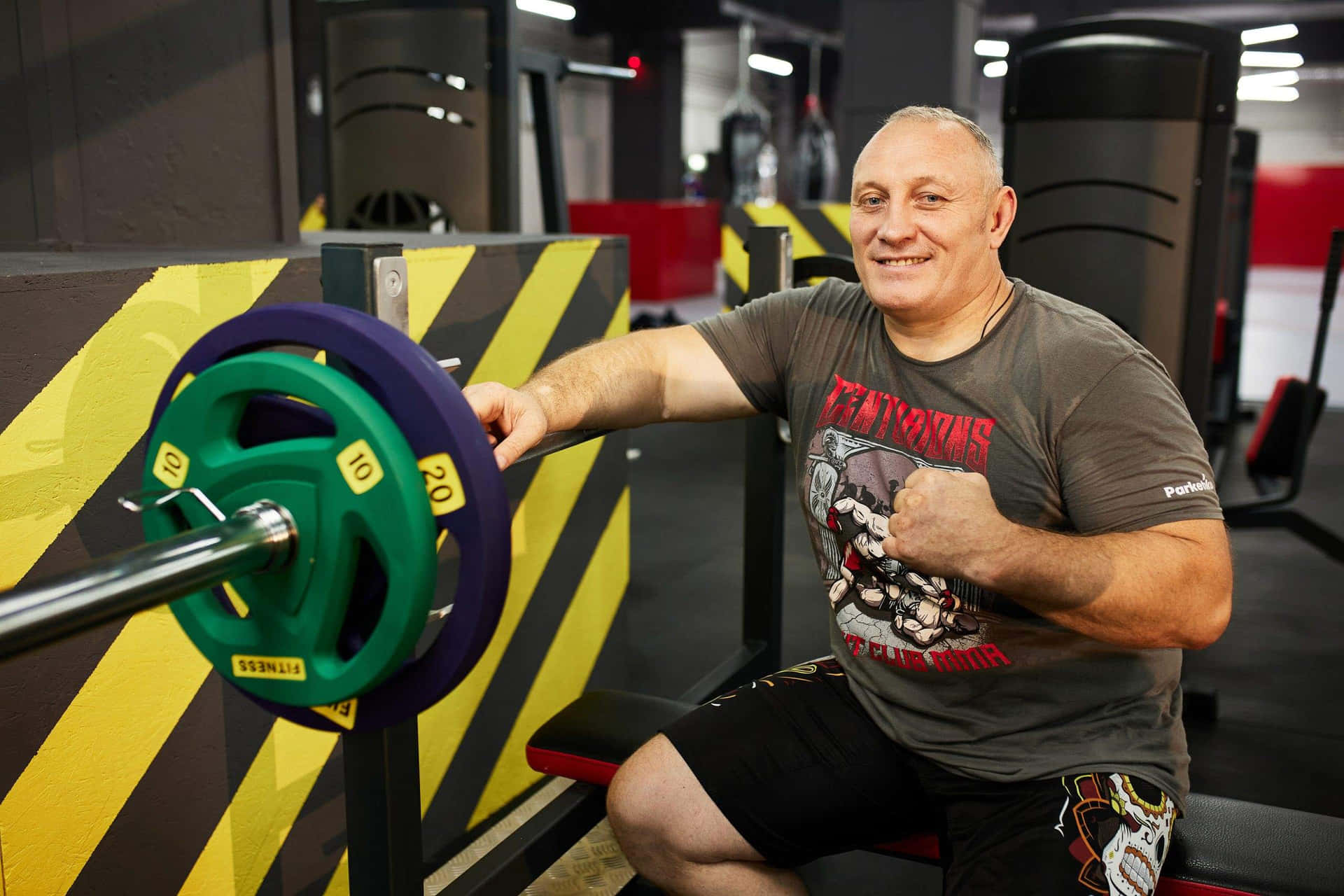 Smiling Man Gym Workout Setup Wallpaper