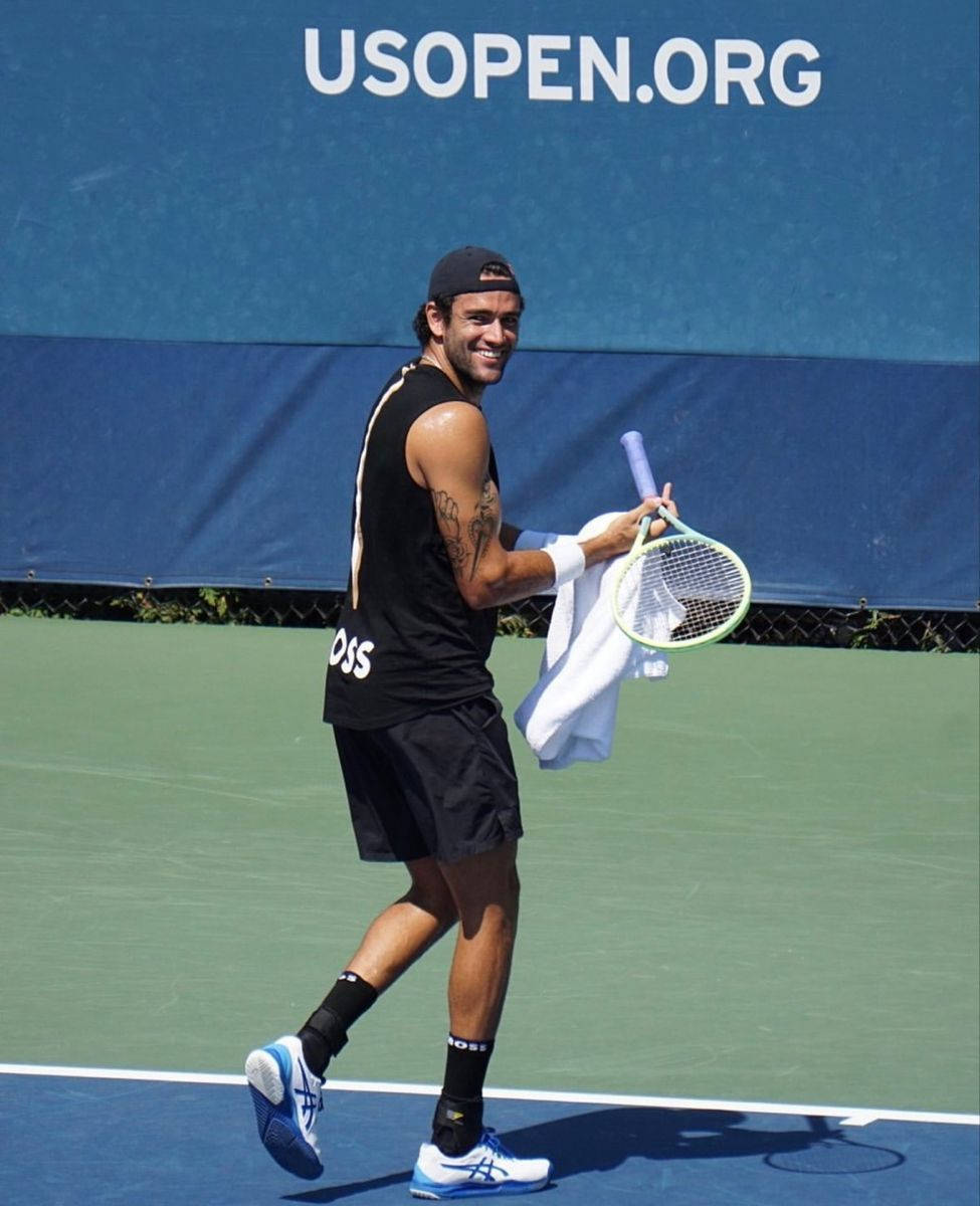 Italian Tennis Pro Matteo Berrettini Delighting in a Light Moment Wallpaper