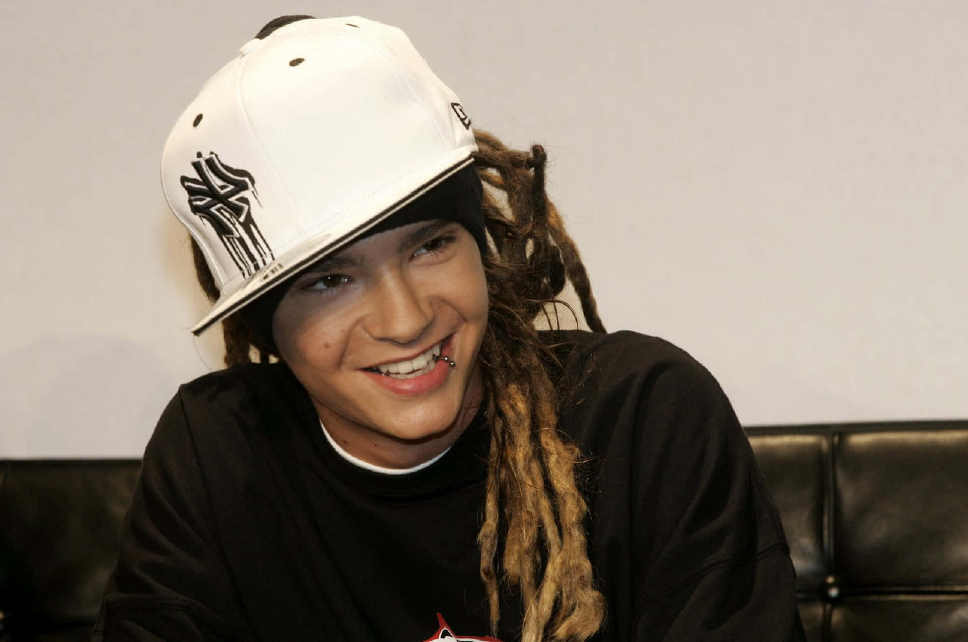 Smiling_ Musician_with_ Dreadlocks_and_ Cap Wallpaper