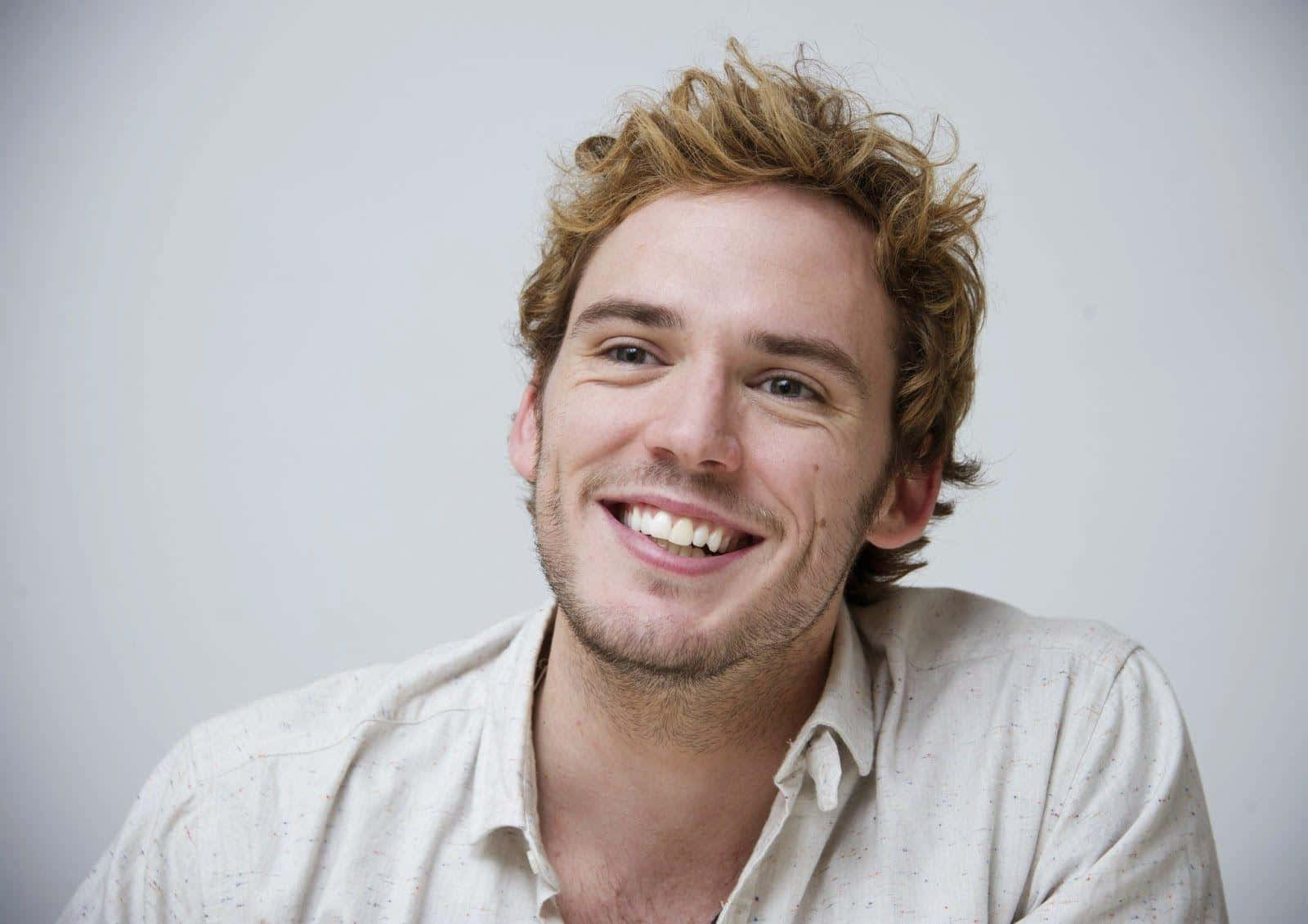 Download Smiling Portrait Of Actor Sam Claflin Wallpaper | Wallpapers.com