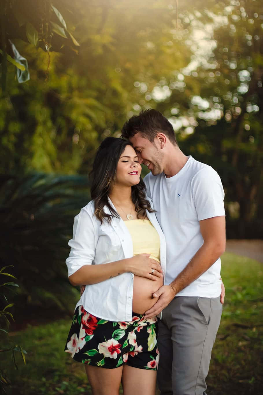 Smiling Pregnant Couple Touching Baby Bump Wallpaper