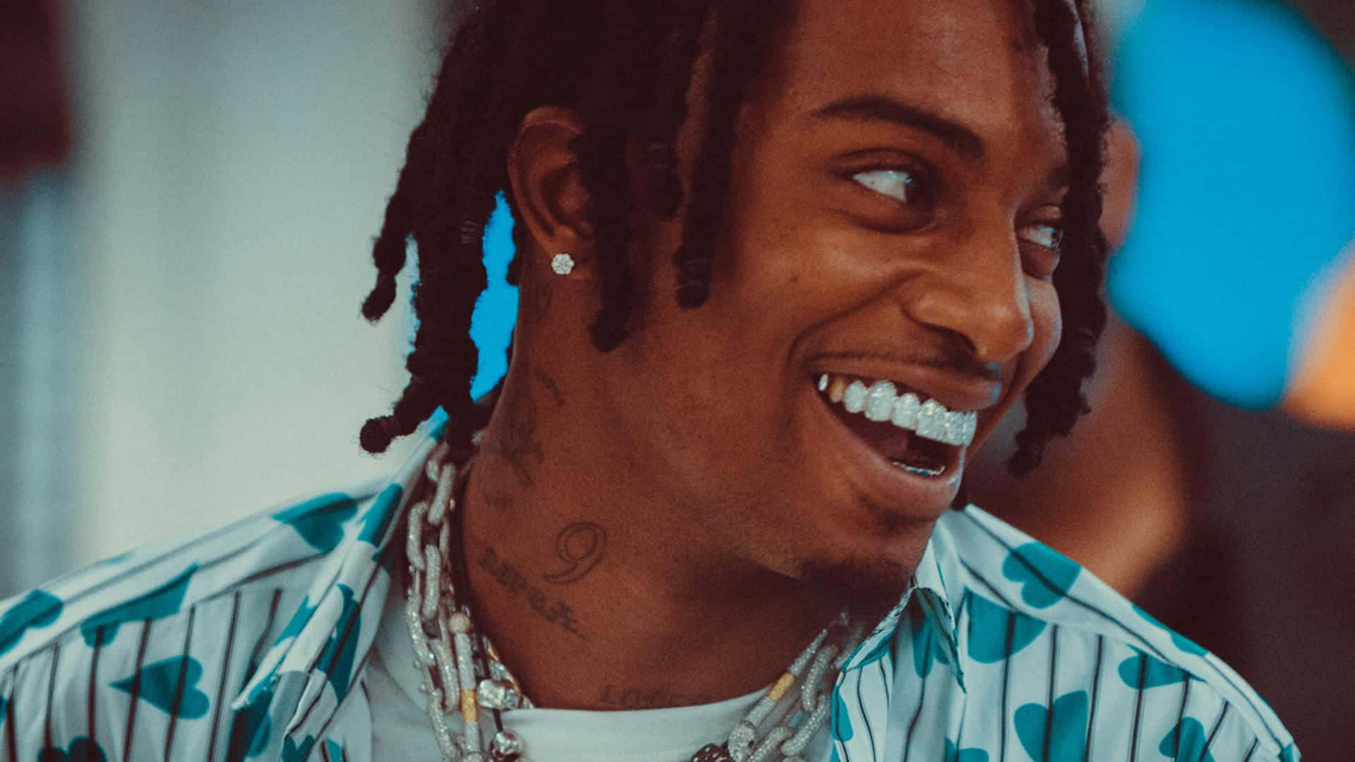 Smiling Rapperwith Dreadlocksand Grillz Wallpaper