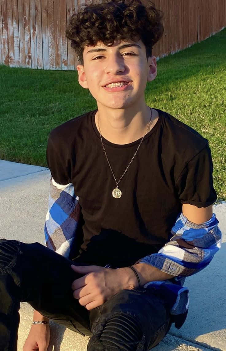 Smiling Teen Boy Outdoors Sunlight Wallpaper
