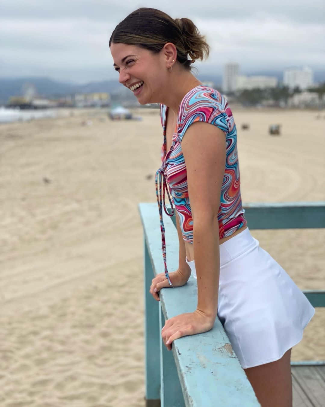 Smiling Woman Beachside Bench Wallpaper