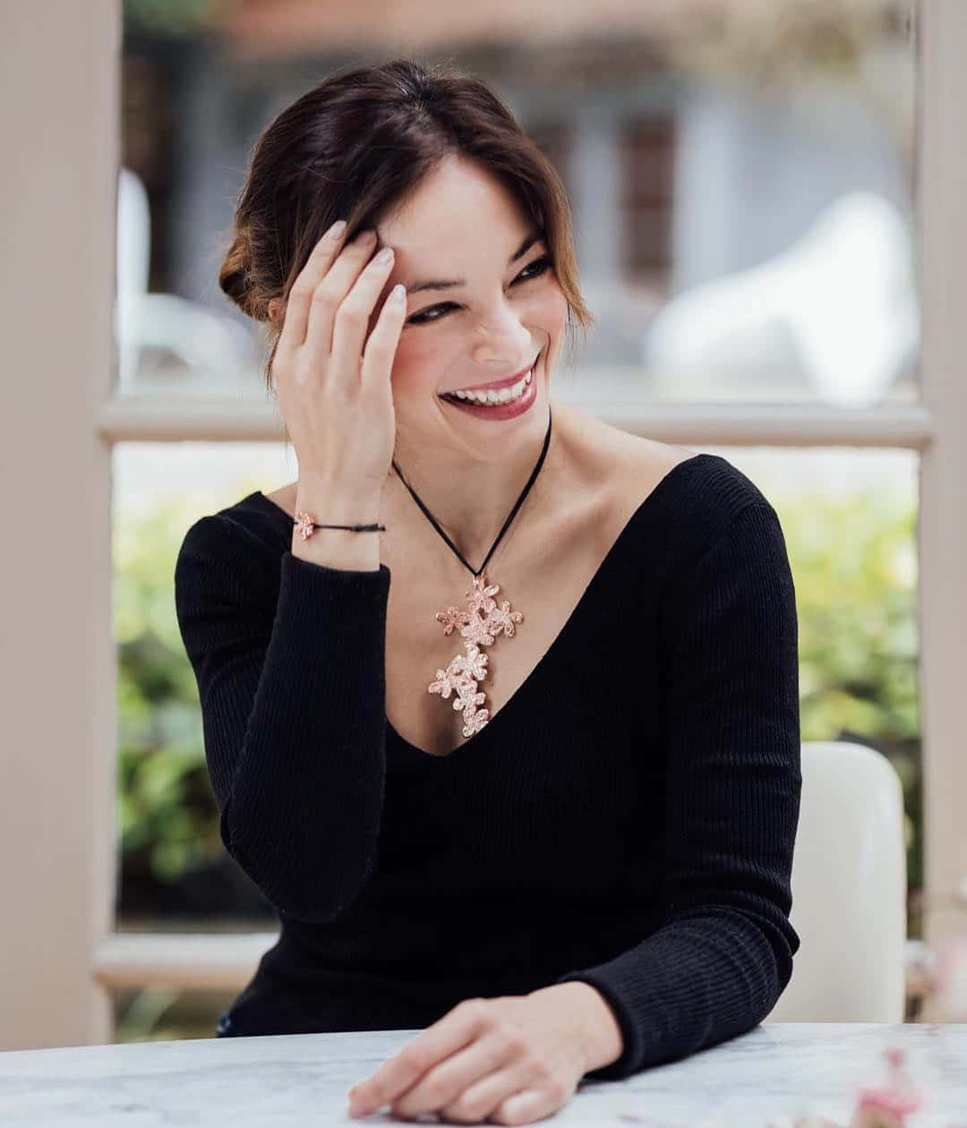 Smiling Woman Black Top Floral Necklace Wallpaper