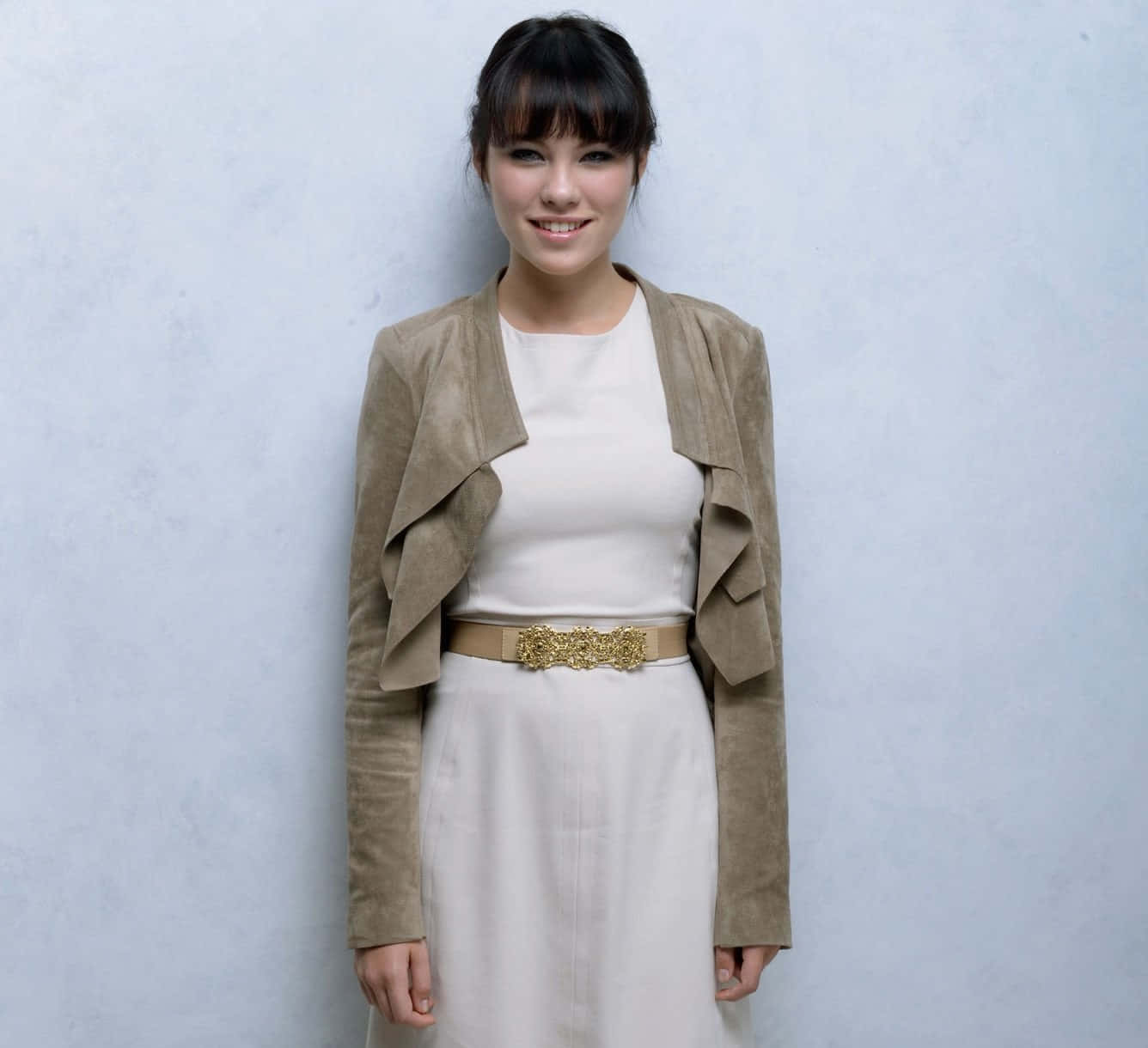 Smiling Womanin White Dressand Beige Jacket Wallpaper