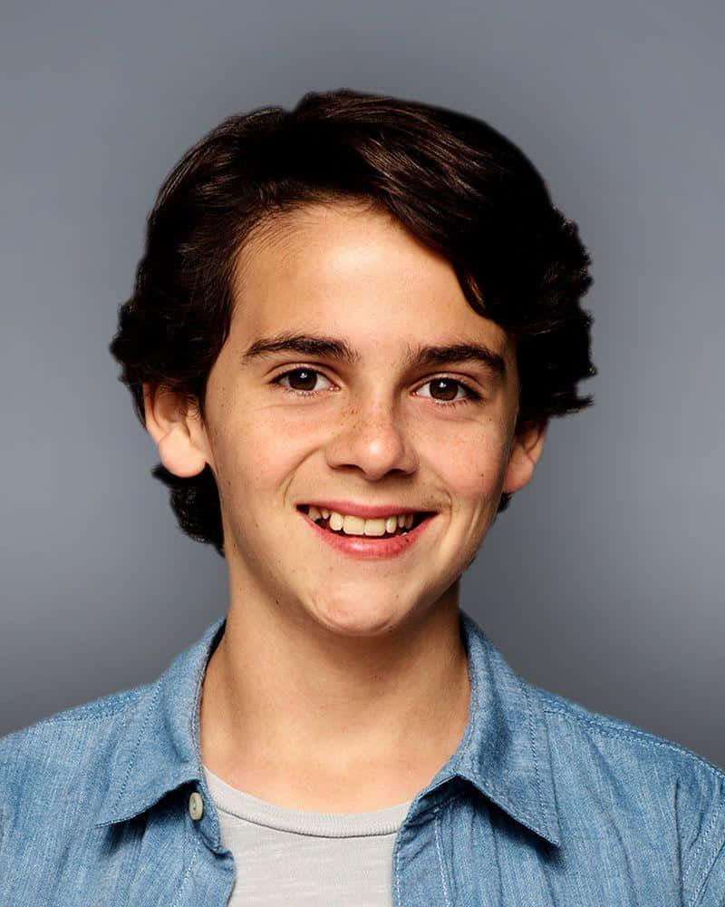Smiling Young Actorin Denim Shirt Wallpaper