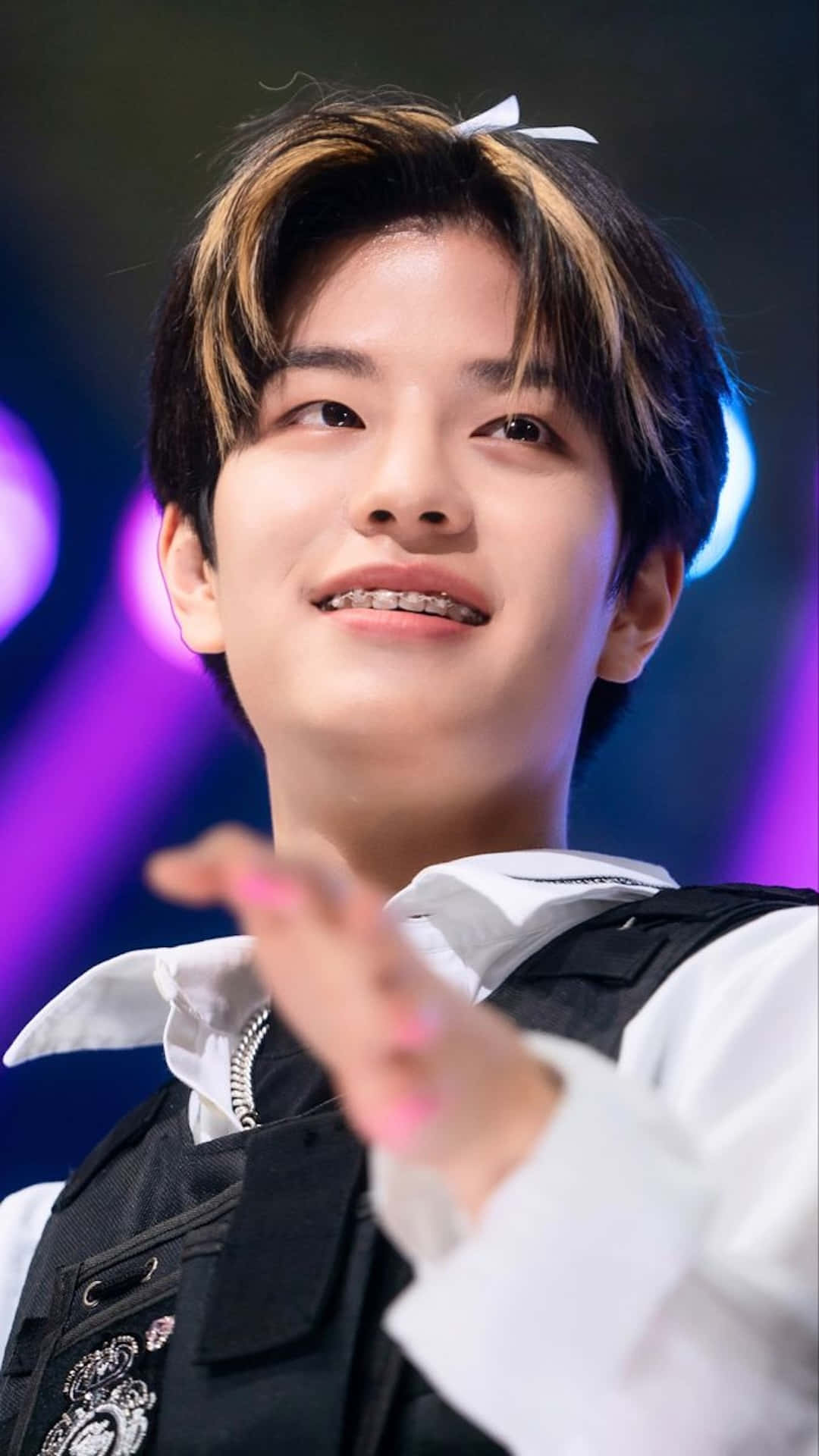 Smiling Young Man Stage Performance Wallpaper