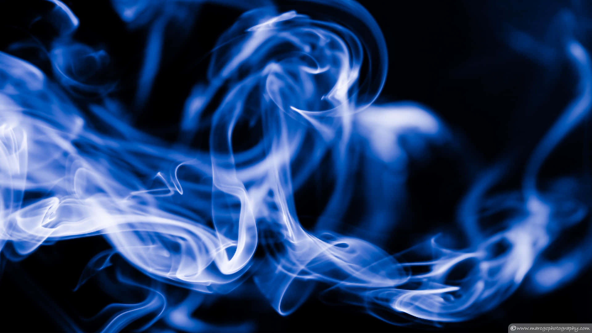 A beautiful photo of abstract smoke aglow in vivid blue Wallpaper