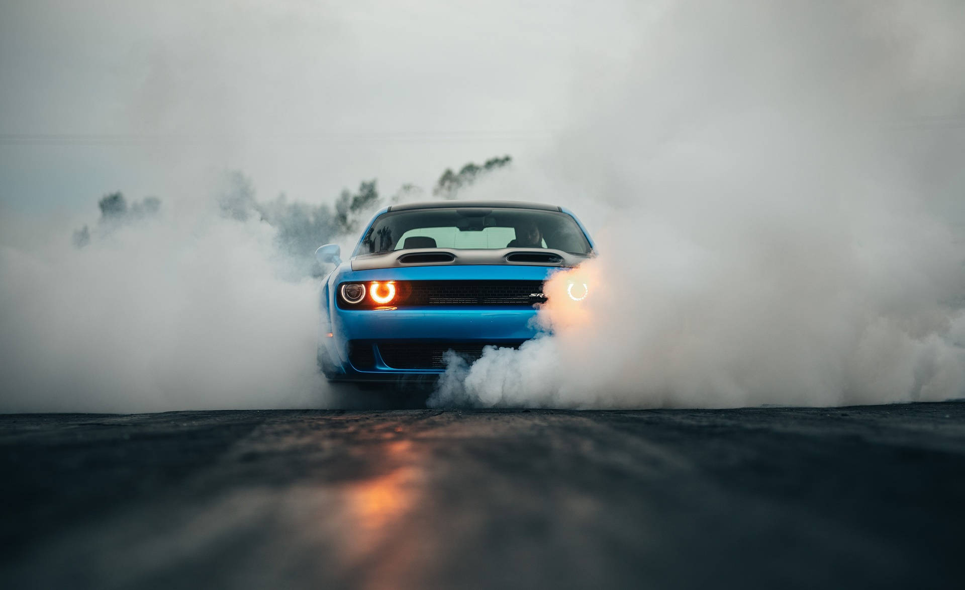 Smoke Surrounding A Blue Dodge Challenger Wallpaper