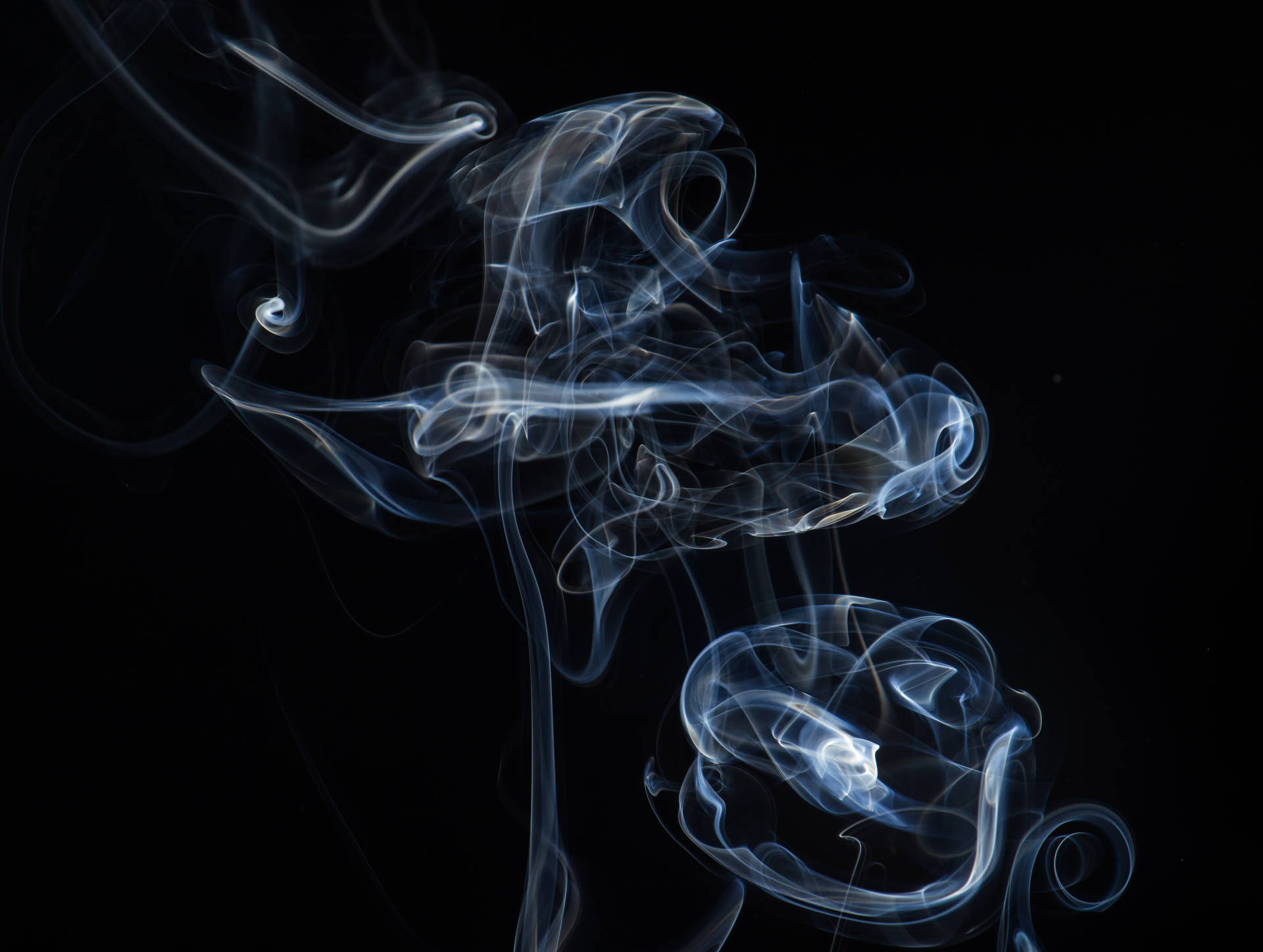 Dark and Mysterious Smoke Swirling Through the Sky Wallpaper