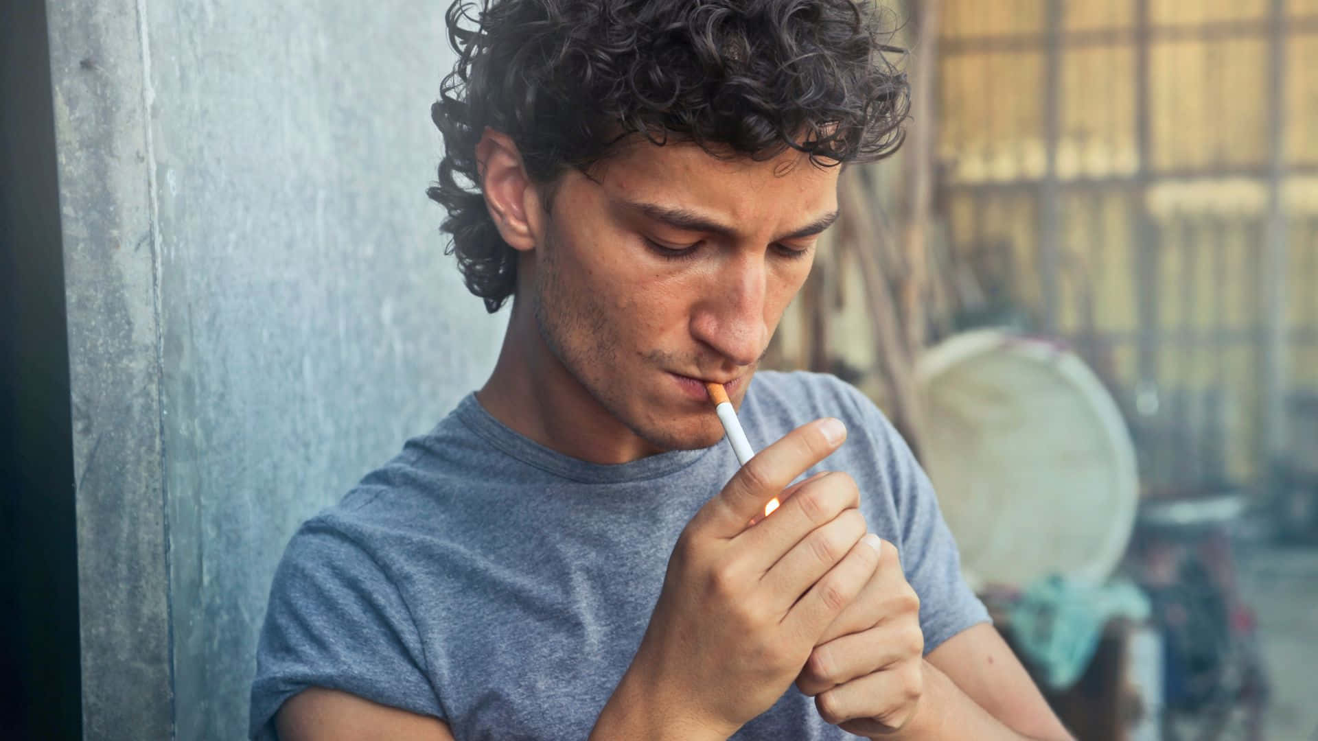 A Young Man Smoking A Cigarette In A Street