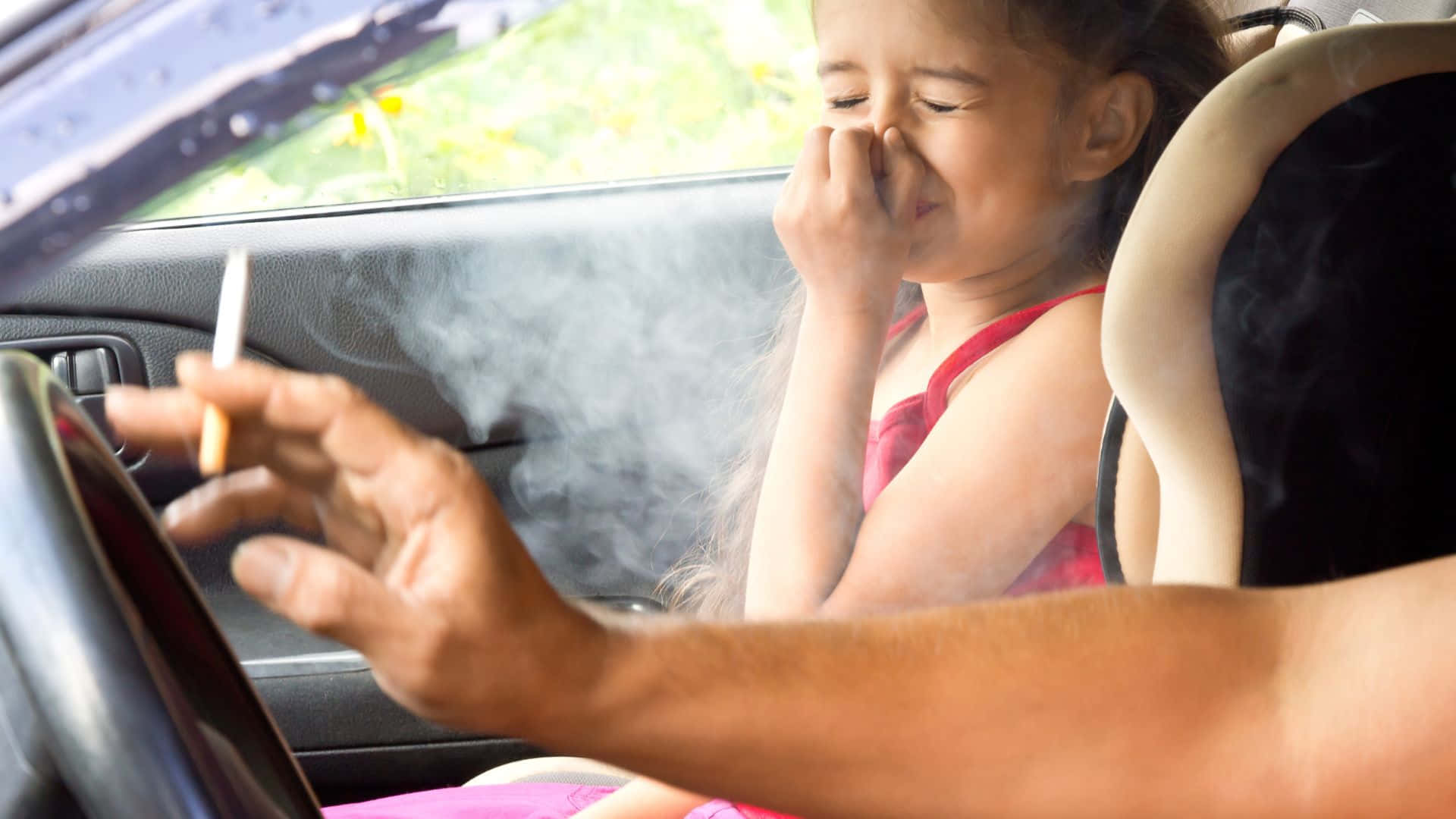 A Girl Is Smoking A Cigarette In A Car