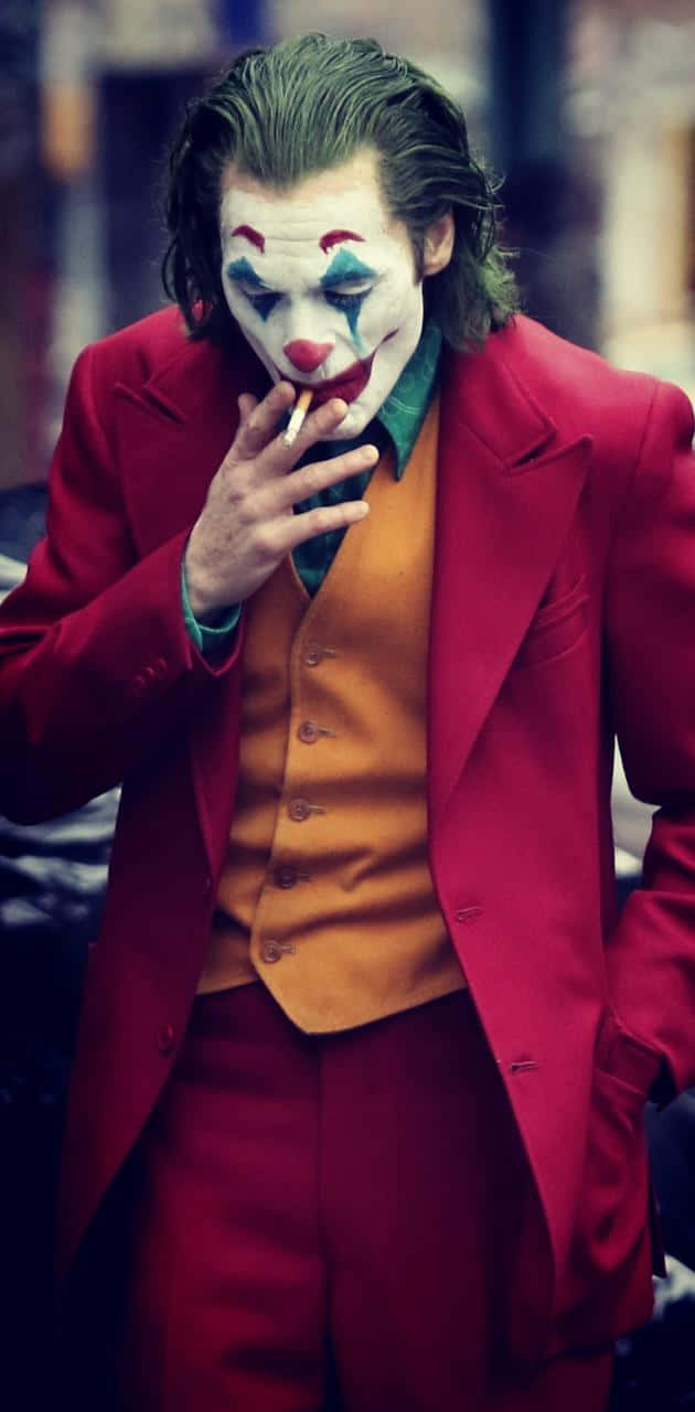 Smoking Joker Pfp In Red Suit Wallpaper