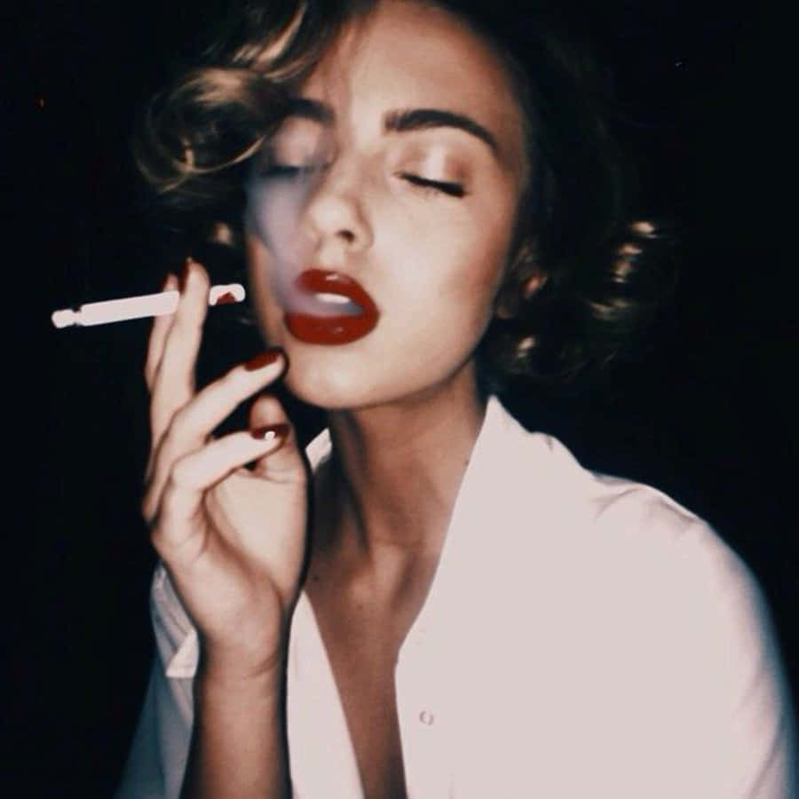 A Woman With Red Lipstick Smoking A Cigarette