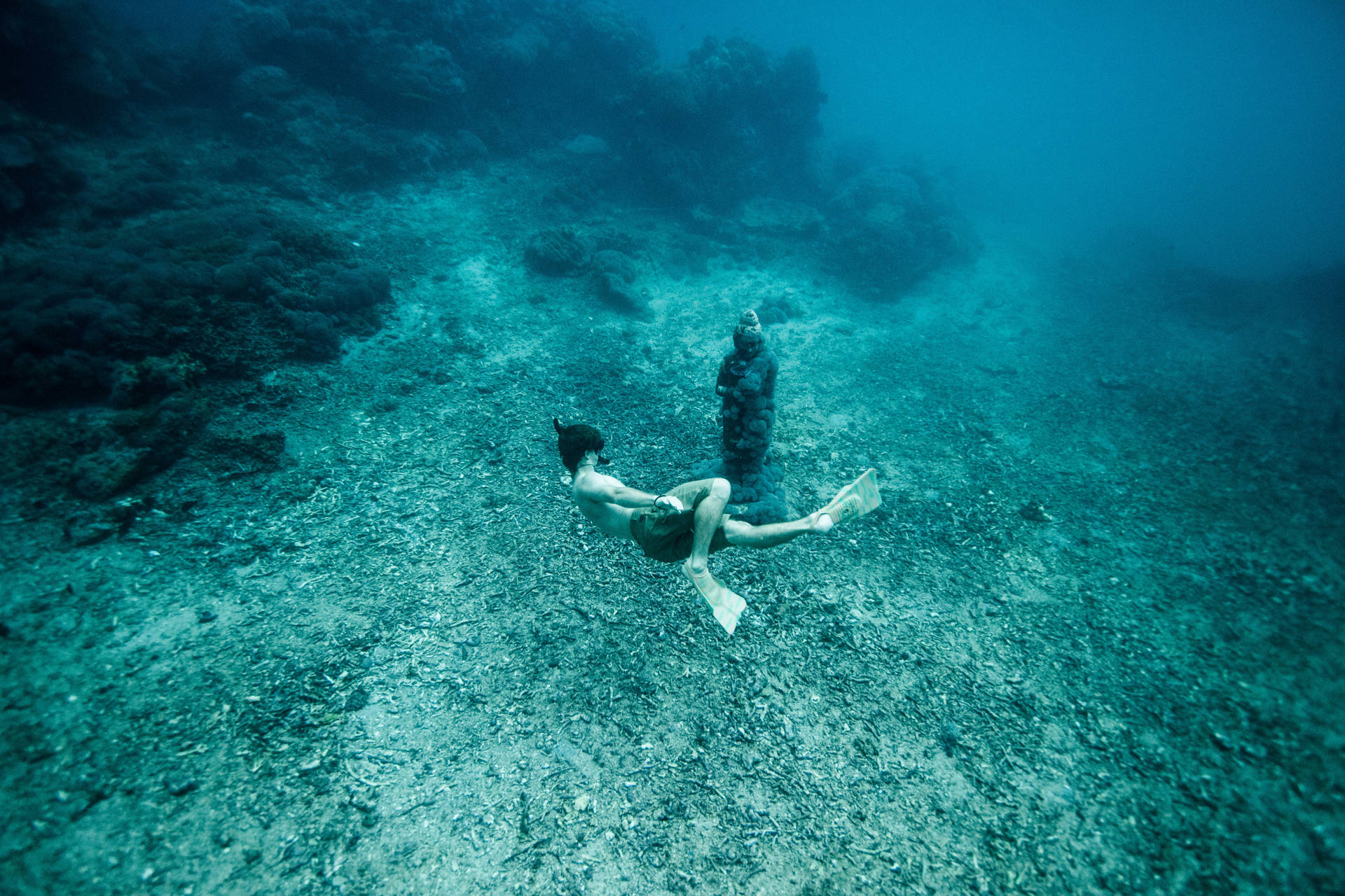 Snorkeling Underwater Rock Sculpture Wallpaper