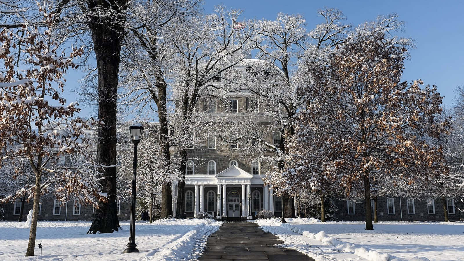 A Large Building With Snow Covered Trees