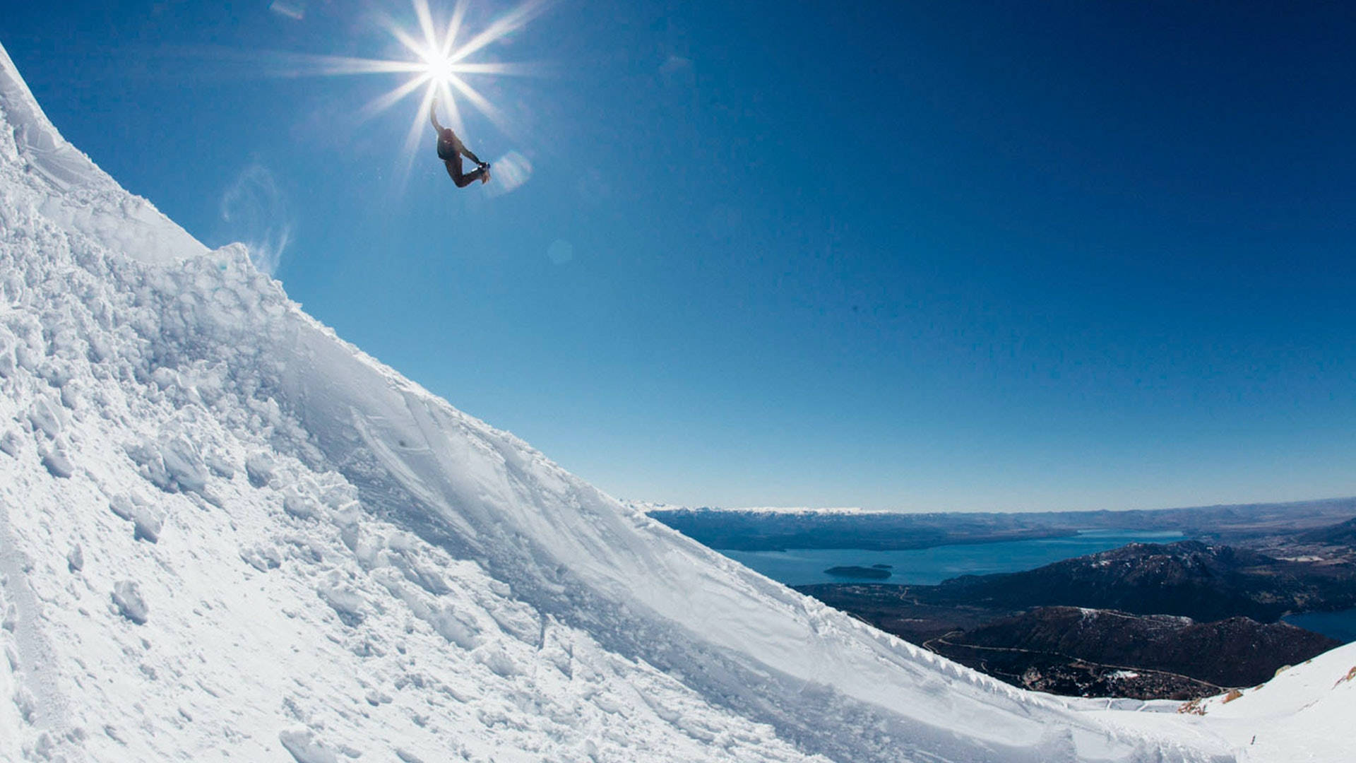 Lo Snowboard Sotto Il Sole Sfondo