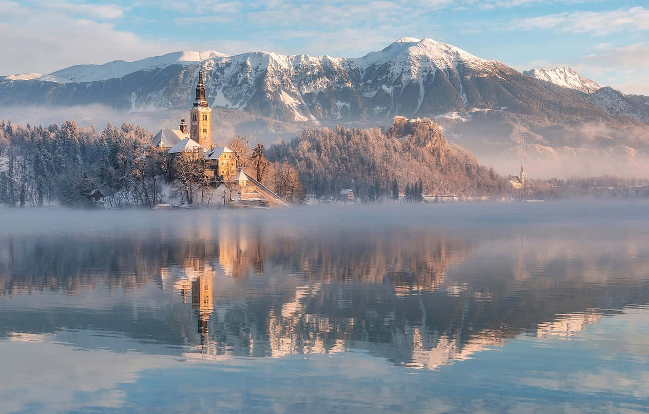 Snowed Summit At The Mountains Of Lake Bled Wallpaper