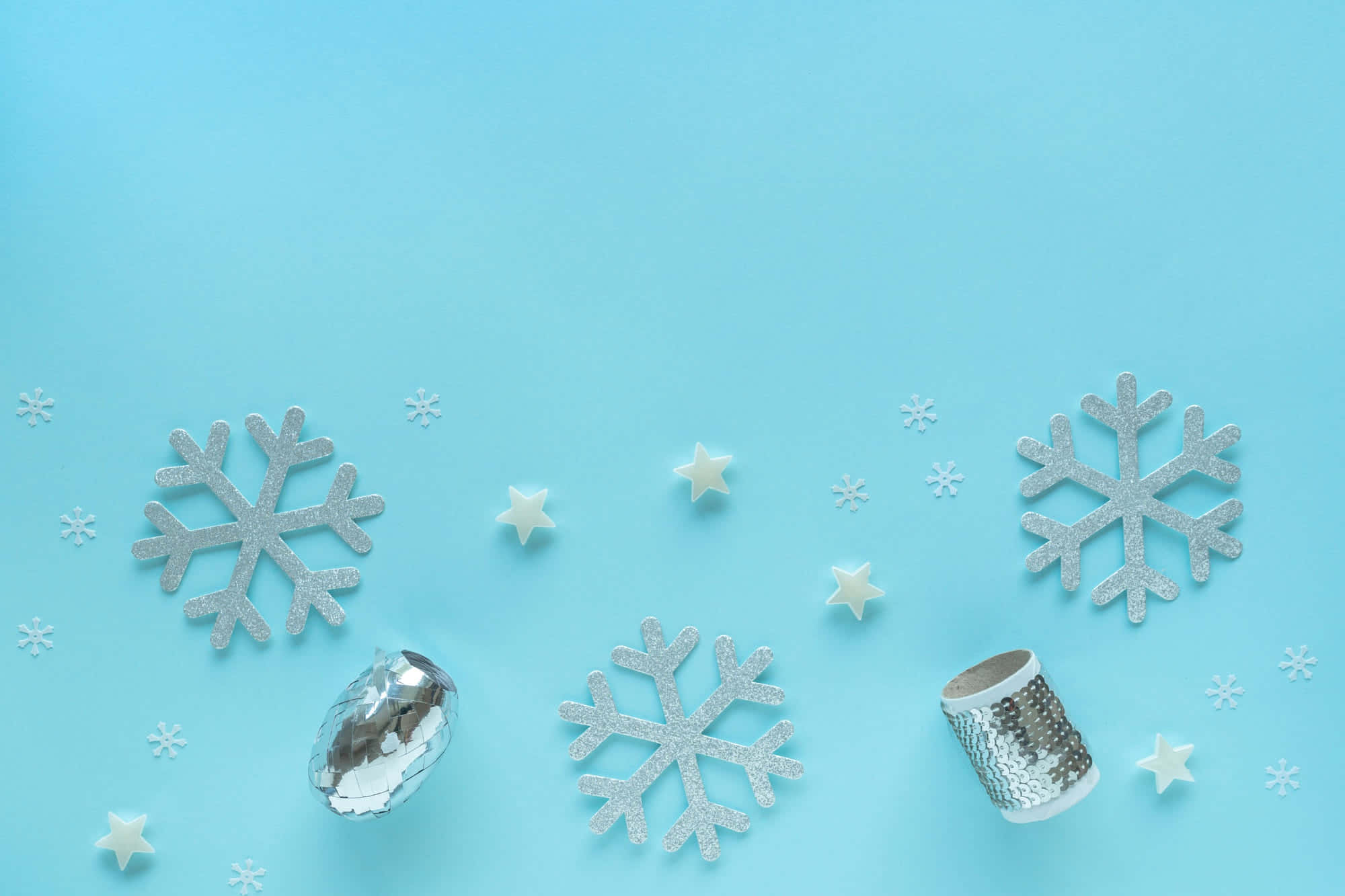 A Blue Background With Snowflakes And Stars