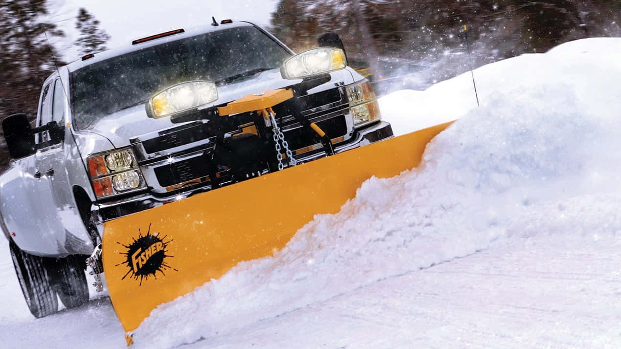 Snowplow clearing the road on a snowy day Wallpaper