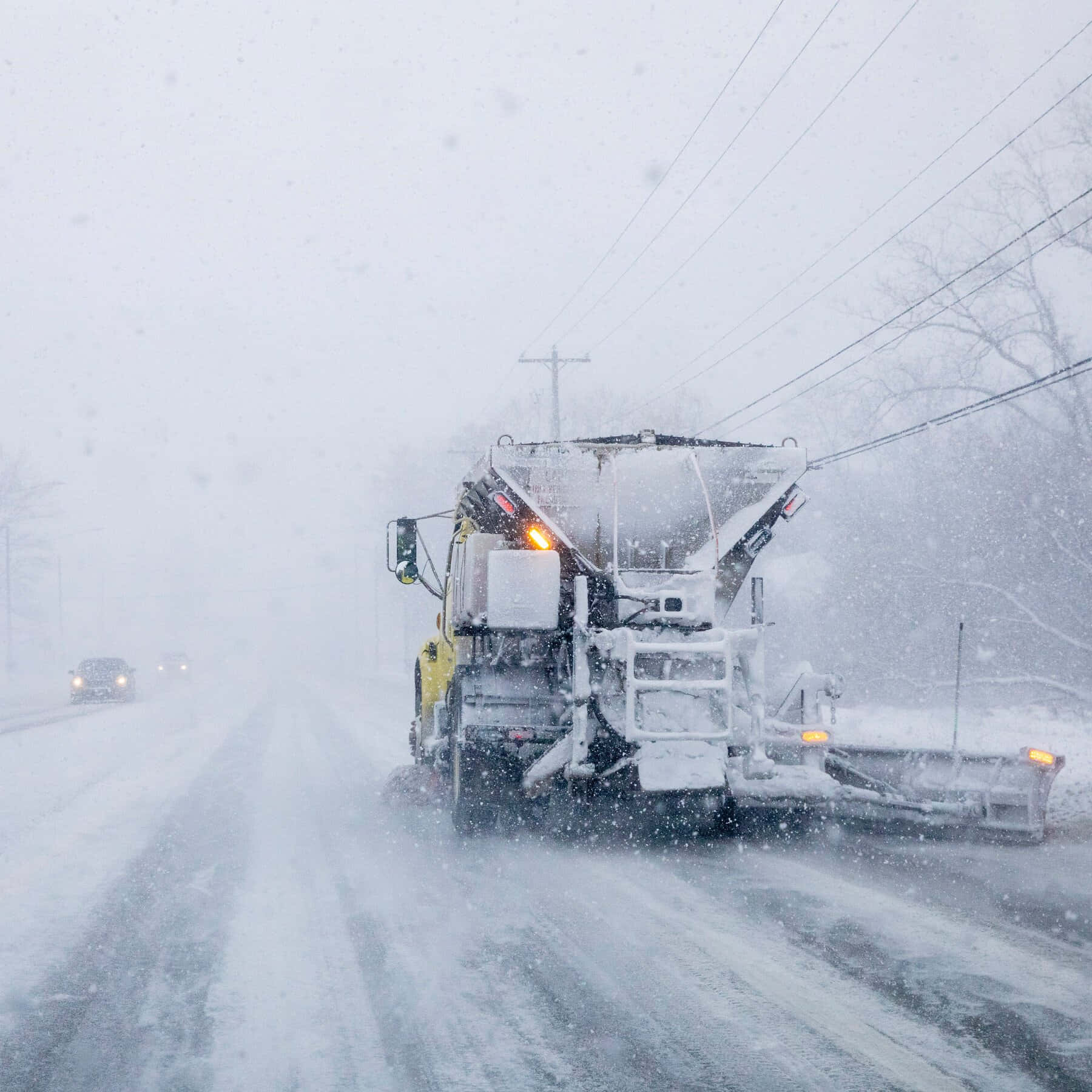 Snowplow Truck Clearing the Road during Wintertime Wallpaper