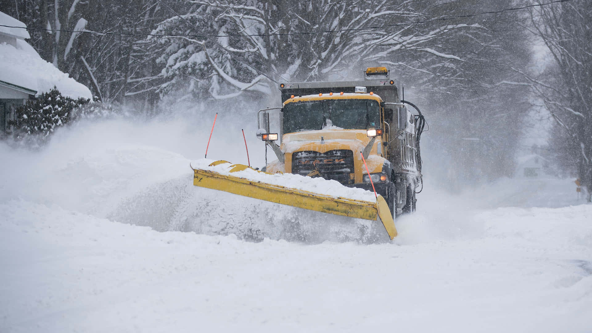 Snowplow clearing the road on a snowy day Wallpaper