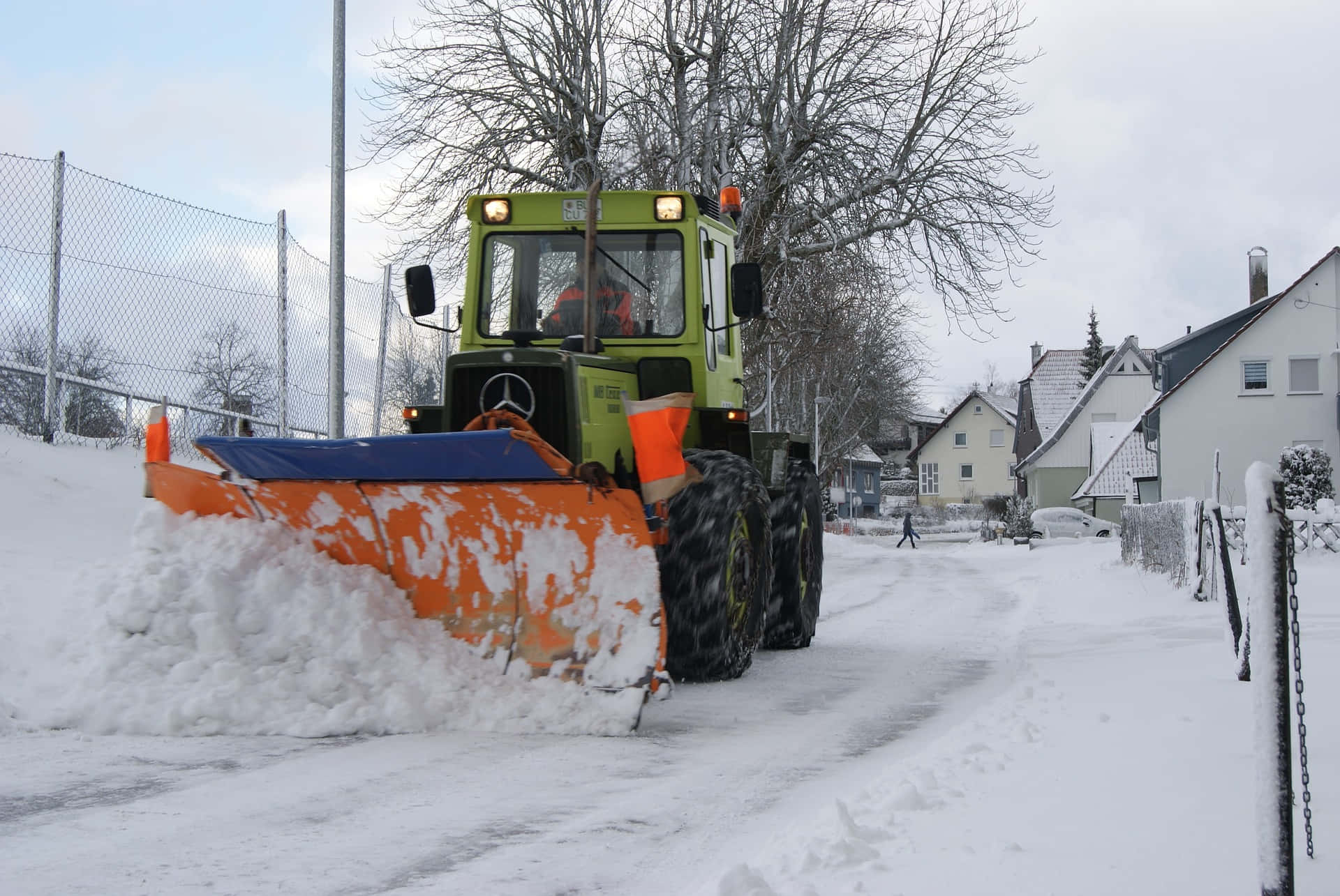 Snowplow clearing a winter road Wallpaper