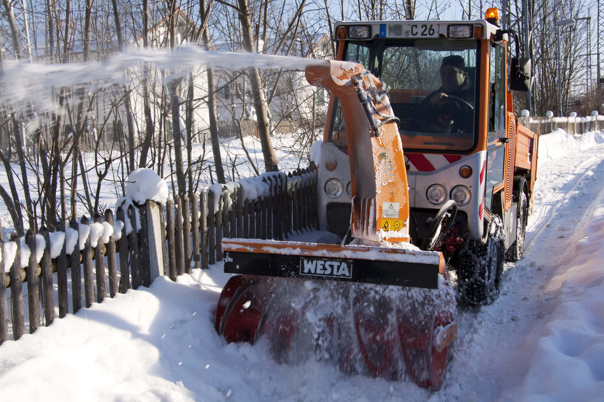 Powerful Snowplow Clearing a Winter Road Wallpaper