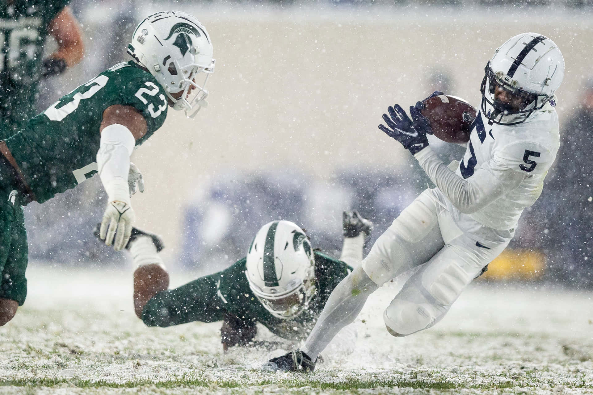 Snowy Football Game Action Wallpaper